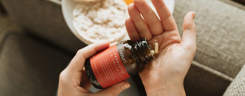 person holding red bottle